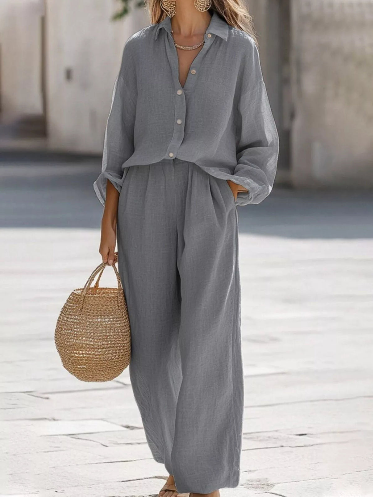 Plus size loose fit shirt and wide leg pants matching set by Trendsi, featuring comfortable, casual clothing in natural fabric.