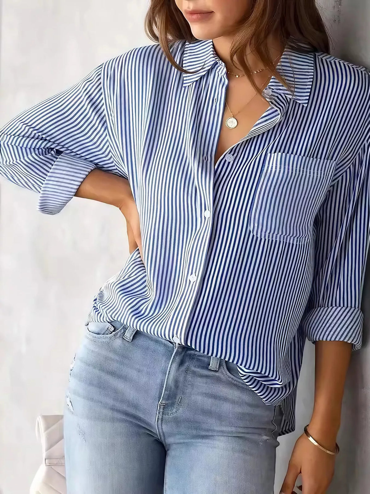 Women's classic striped button-down shirt by Trendsi, featuring a stylish pattern and collared design, perfect for casual or formal wear.