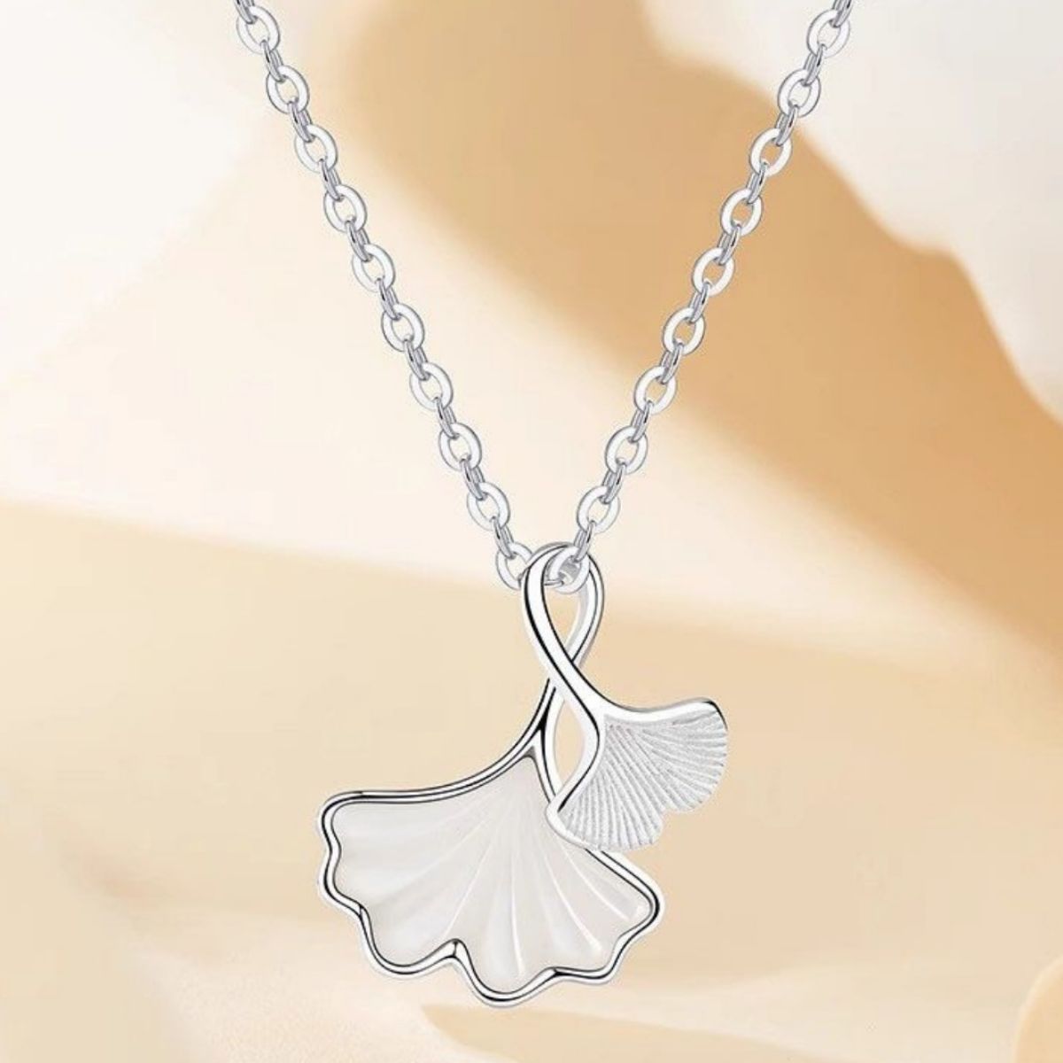 Ginkgo leaf pendant necklace featuring a silver-tone leaf charm on a delicate chain, stylish jewelry by Plush Fashion Hub.