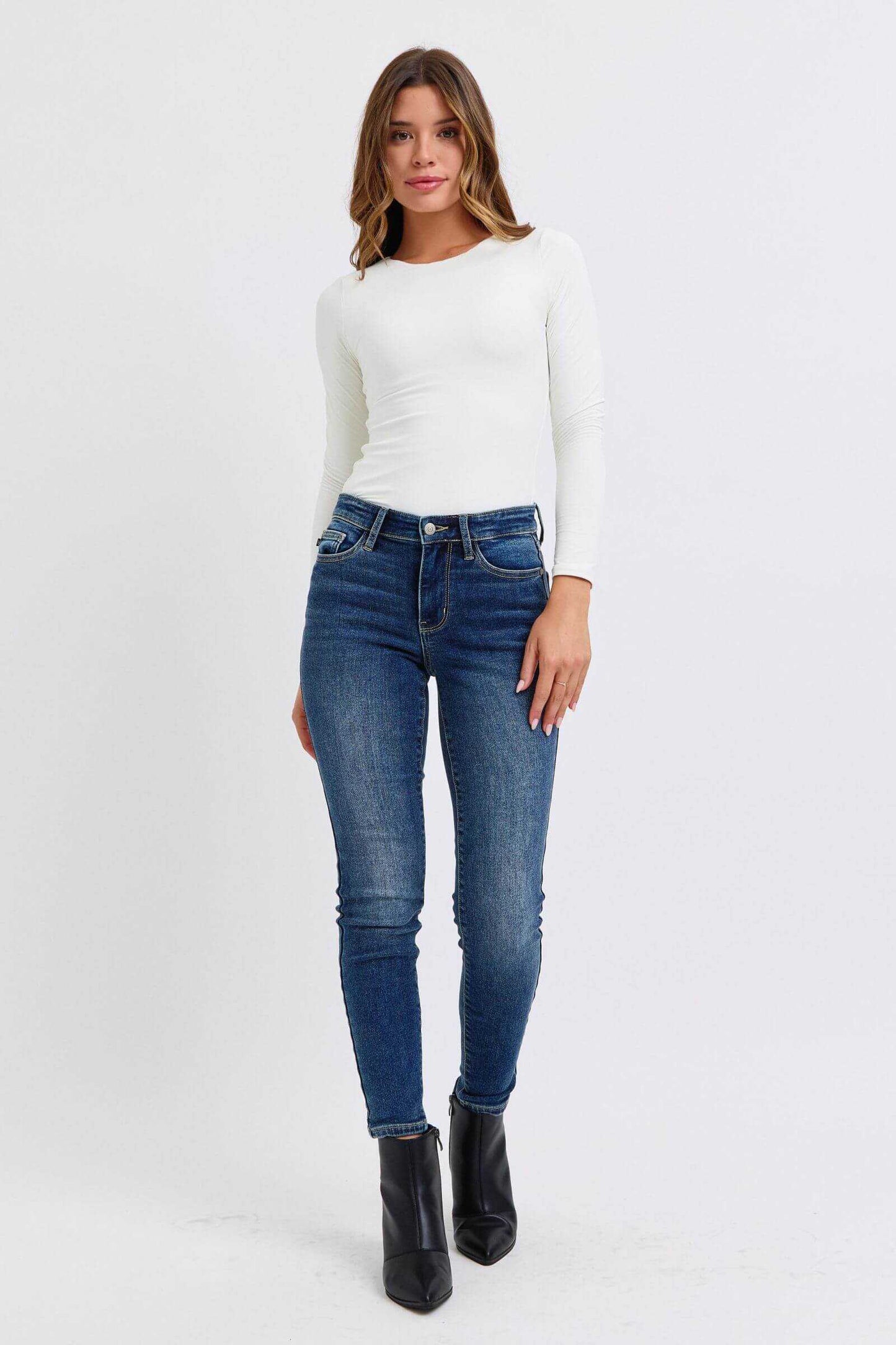 Judy Blue Full Size Run Mid-Rise Waist Skinny Jeans with Thermal Lining, modeled with casual outfit.