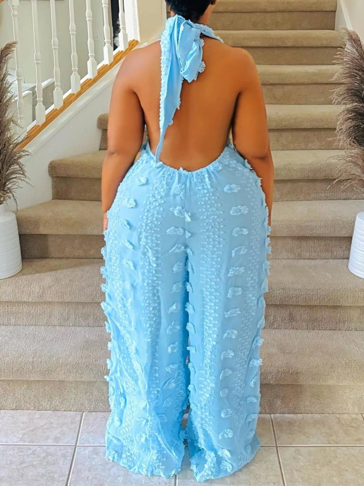Textured halter wide-leg jumpsuit for women by Trendsi, featuring a stylish design and comfortable fit in the image.