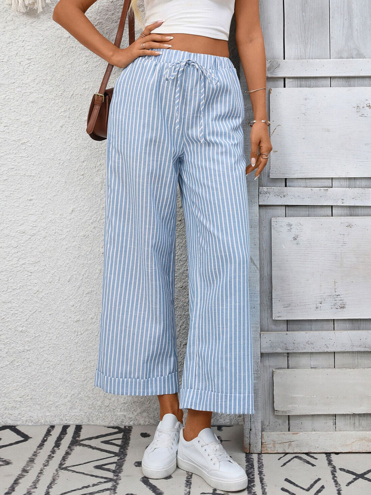 Women’s striped wide-leg drawstring pants with pockets from Plush Fashion Hub, featuring a comfortable fit and stylish design.