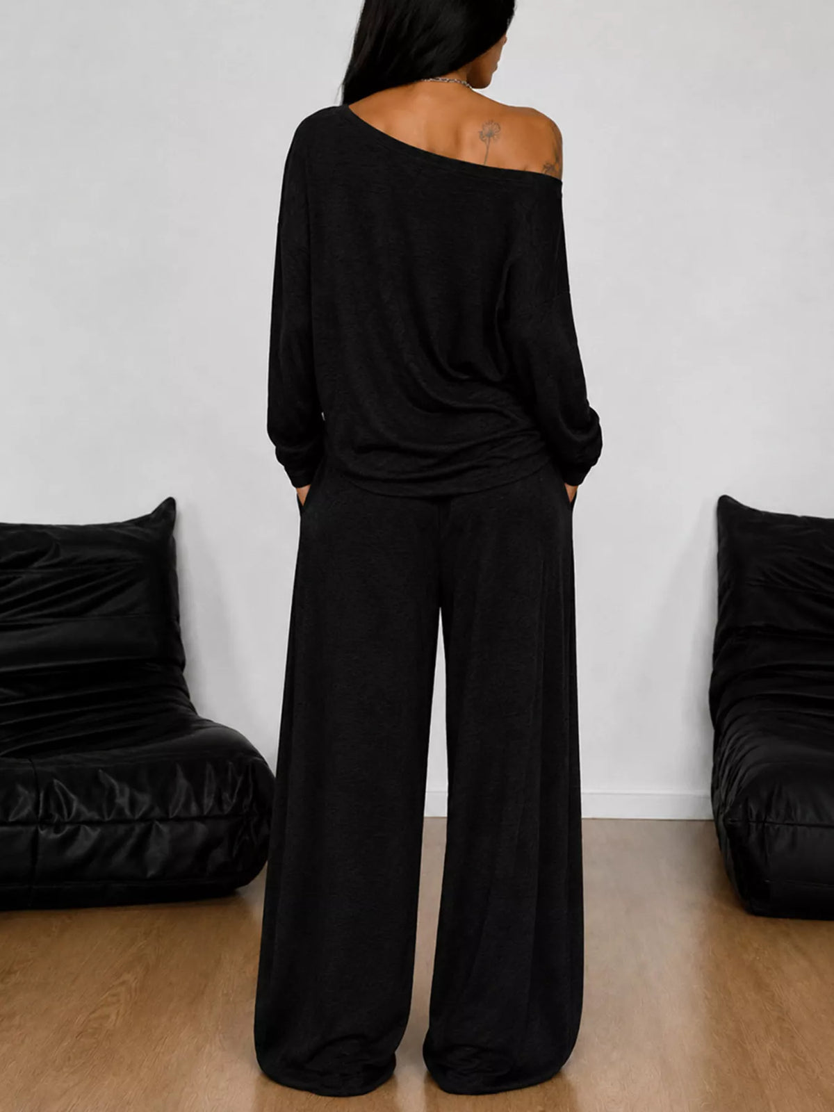 Plus size one-shoulder top and drawstring pants set by Trendsi, featuring a stylish matching set with a modern, relaxed fit.