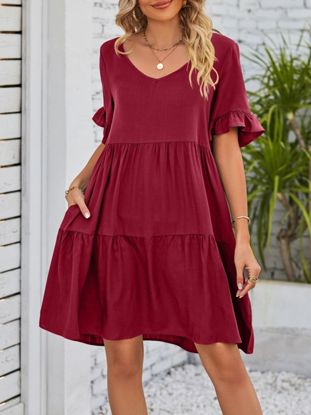 Lightweight rayon mini dress with ruffled sleeves, tiered design, and pockets from Plush Fashion Hub.