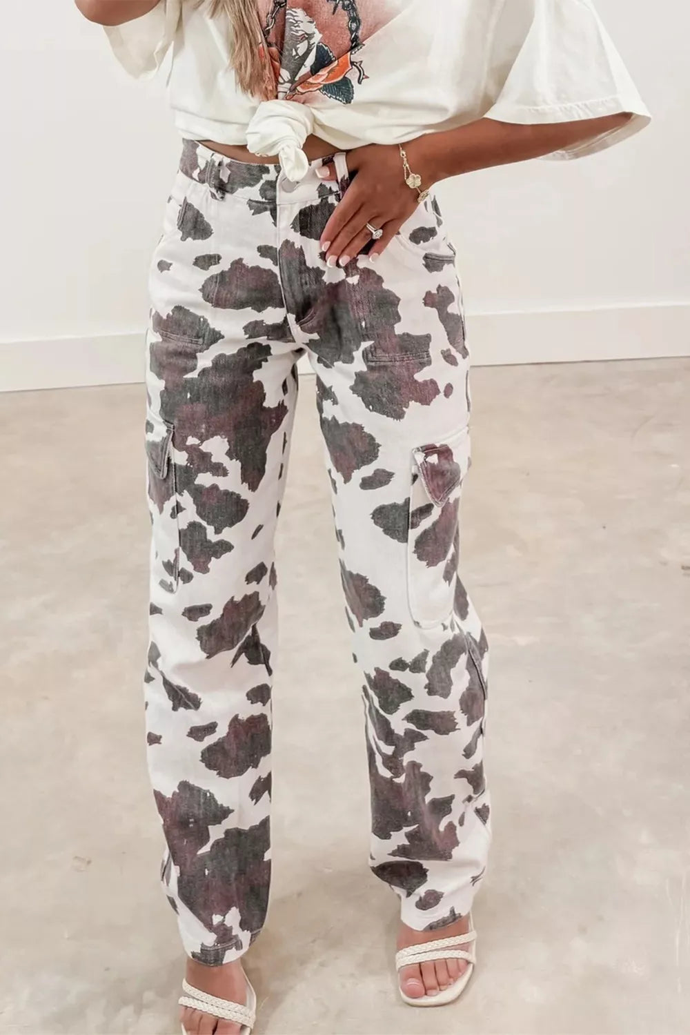 Cow spots printed Plush Fashion Hub jeans with multiple pockets, featuring a stylish cow print pattern and classic denim design.