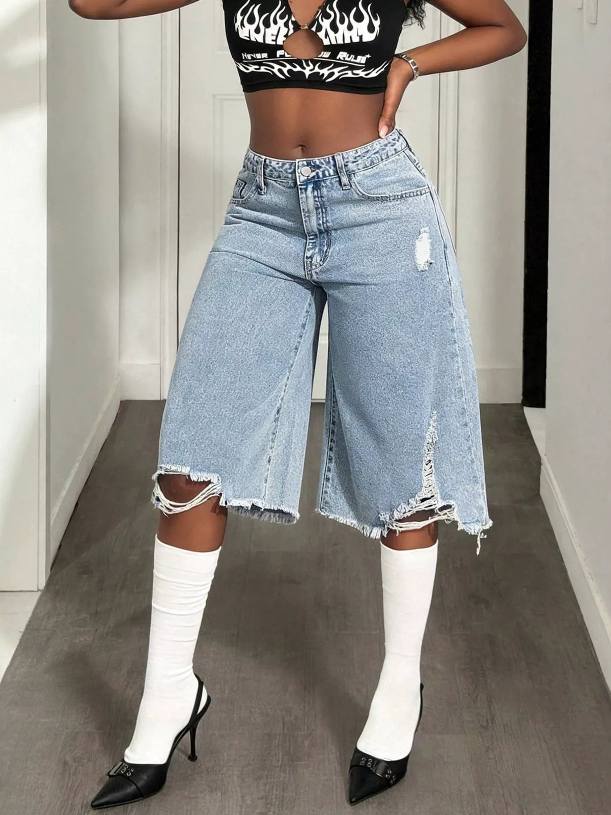 Distressed wide-leg denim shorts from Plush Fashion Hub featuring a relaxed fit and stylish frayed hem.