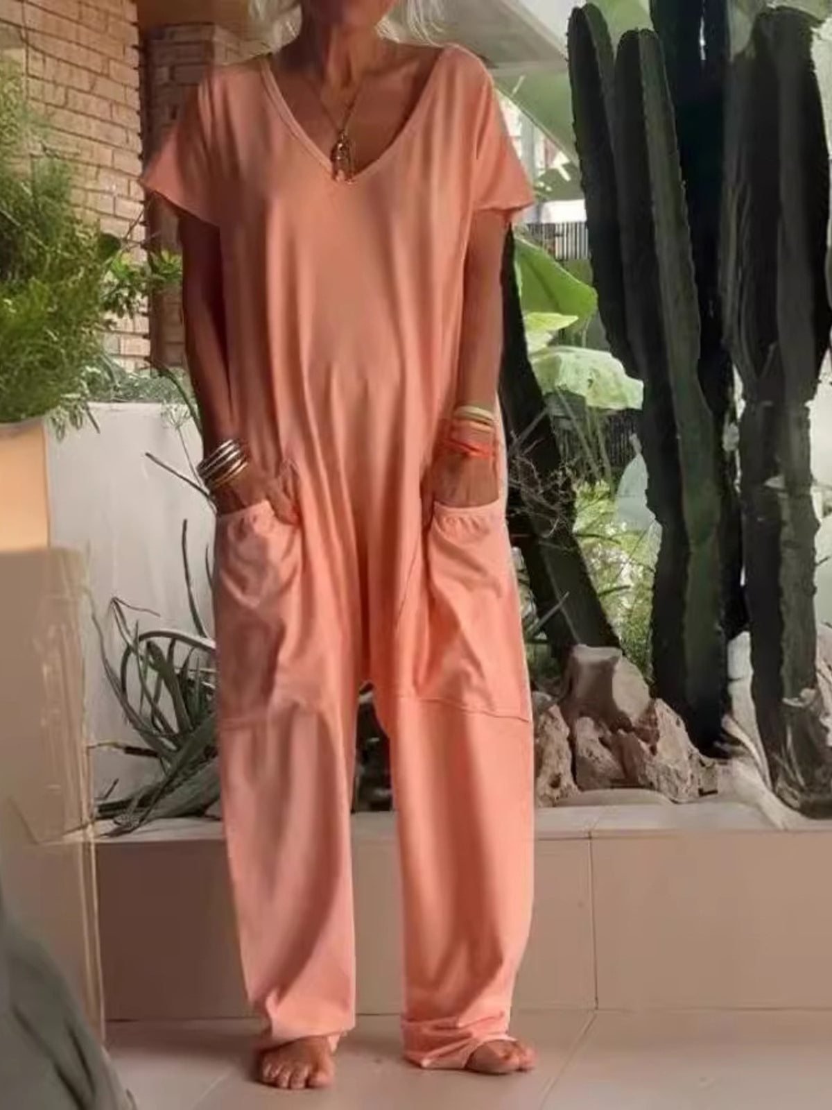 Plus size loose fit V-neck short sleeve wide-leg jumpsuit from Trendsi, featuring a comfortable and stylish full-size design.