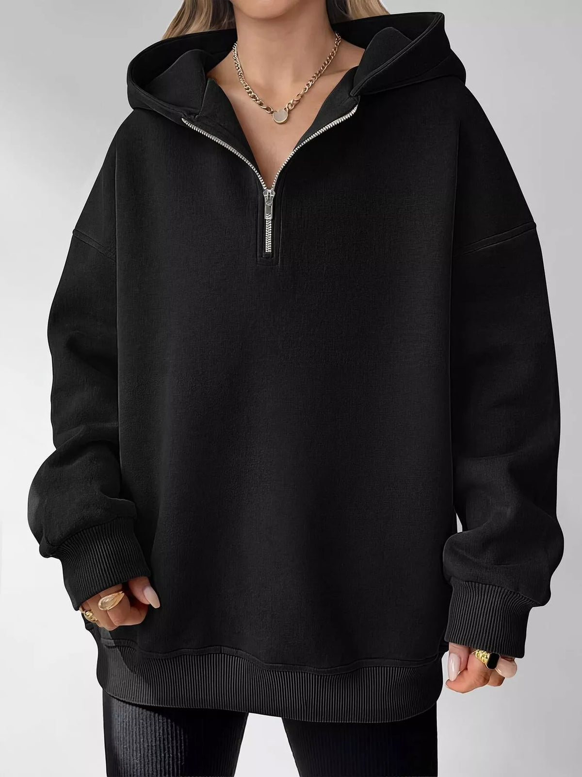 Oversized quarter-zip hoodie from Trendsi, shown in a casual tops style, featuring a relaxed fit and soft fabric in natural setting.