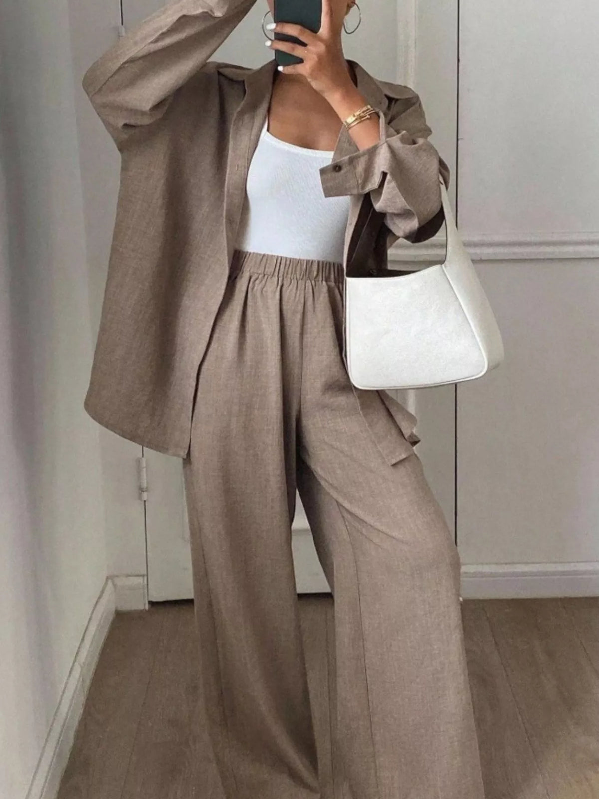 Trendsi long sleeve button-up shirt and wide-leg pants set, featuring a stylish, coordinated outfit with a comfortable fit and modern design.