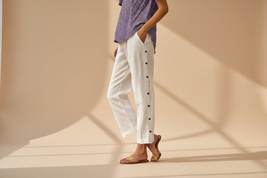 FitiqueFit casual cropped pants with decorative buttons along the side seams, showcasing a stylish, comfortable design.