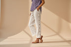 FitiqueFit casual cropped pants with decorative buttons along the side seams, showcasing a stylish, comfortable design.