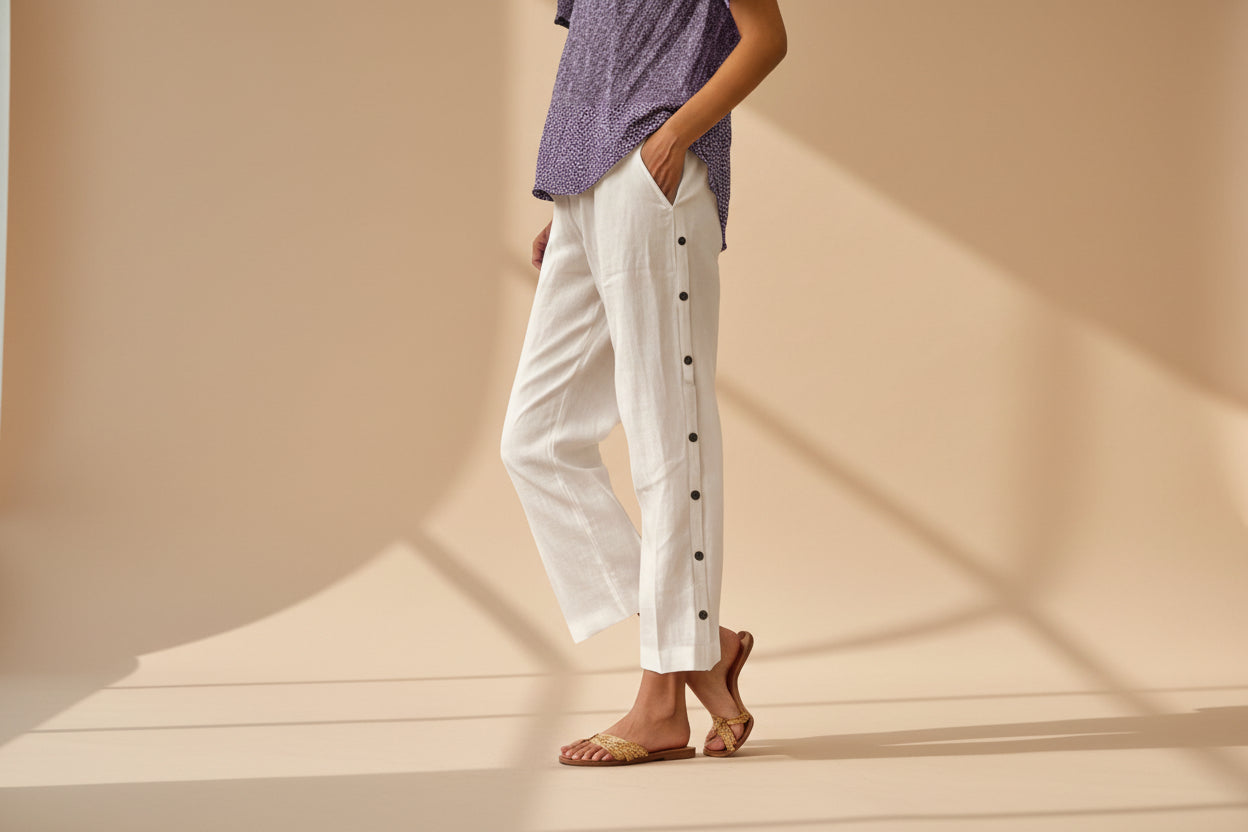 FitiqueFit casual cropped pants with decorative buttons along the side seams, showcasing a stylish, comfortable design.