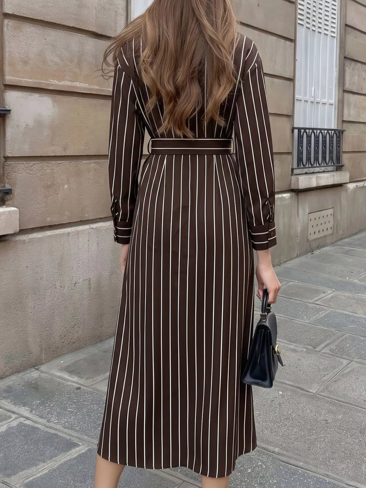Striped long sleeve belted shirt dress for women by Trendsi, featuring a casual fit with a waist belt and button front.