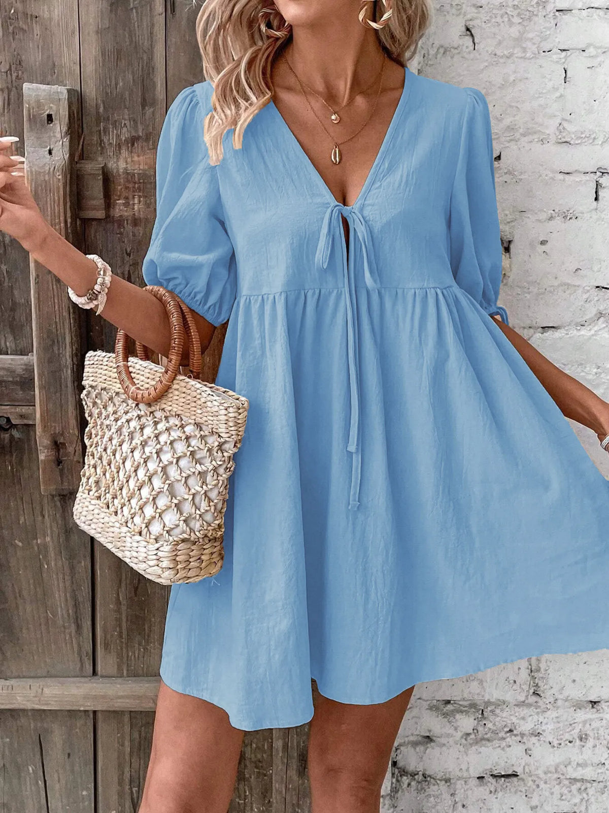 Cotton V-neck tie-front mini dress with puff sleeves by Plush Fashion Hub, featuring a stylish and casual design.