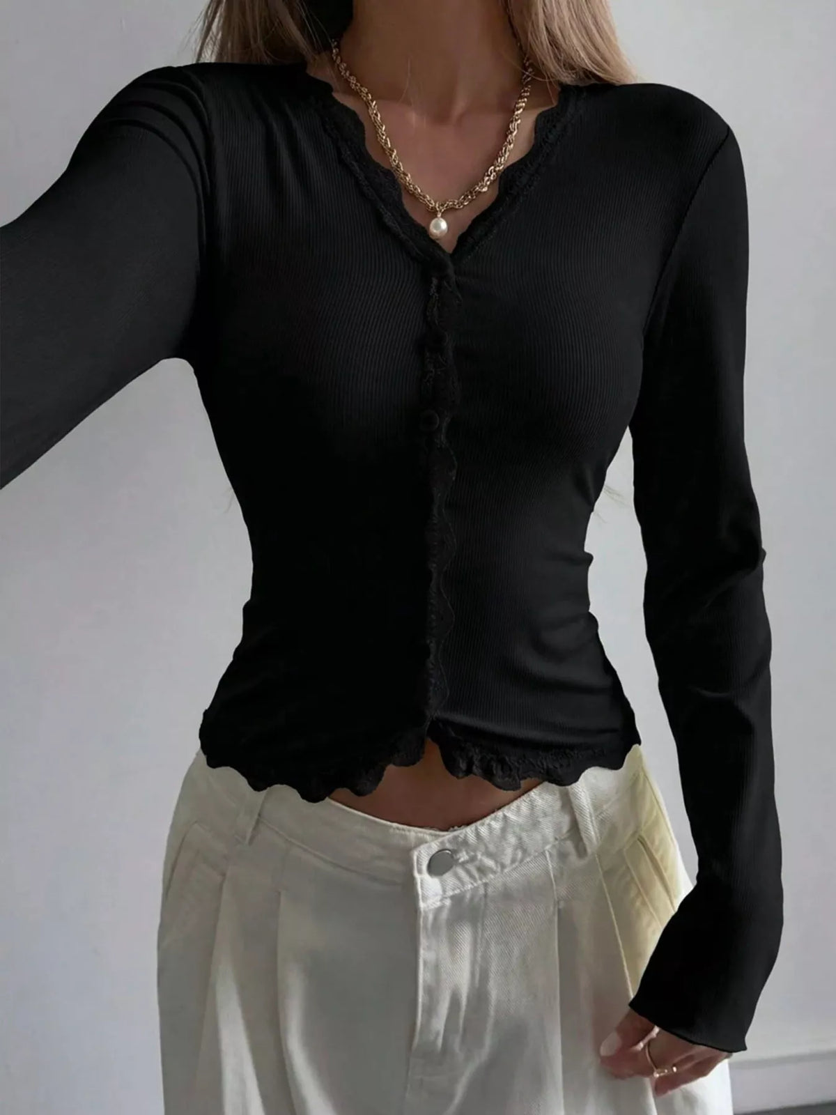 Ribbed long sleeve blouse with lace trim and V-neck, stylish and fitted, from Trendsi.