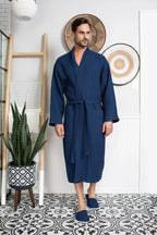 Cotton waffle spa bathrobe for men by Lotus Linen, lightweight and absorbent, shown hanging on a hook.