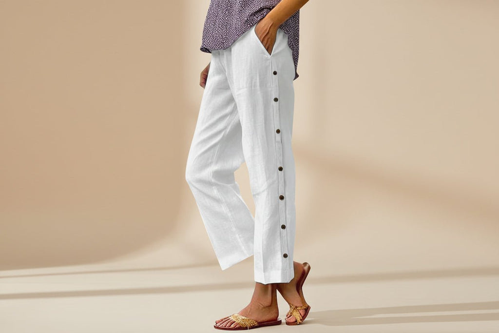 FitiqueFit casual cropped pants with decorative buttons along the side seams, showcasing a stylish, modern design.