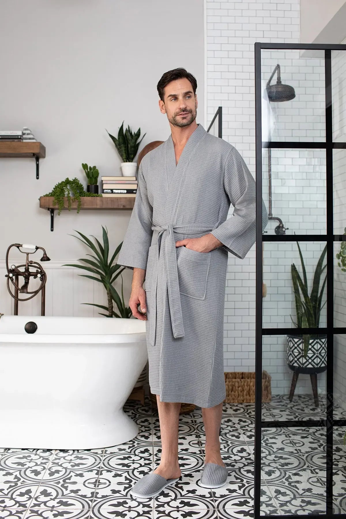 Lightweight, absorbent waffle spa bathrobe for men by Lotus Linen, shown hanging on a hook with a relaxed fit and soft texture.