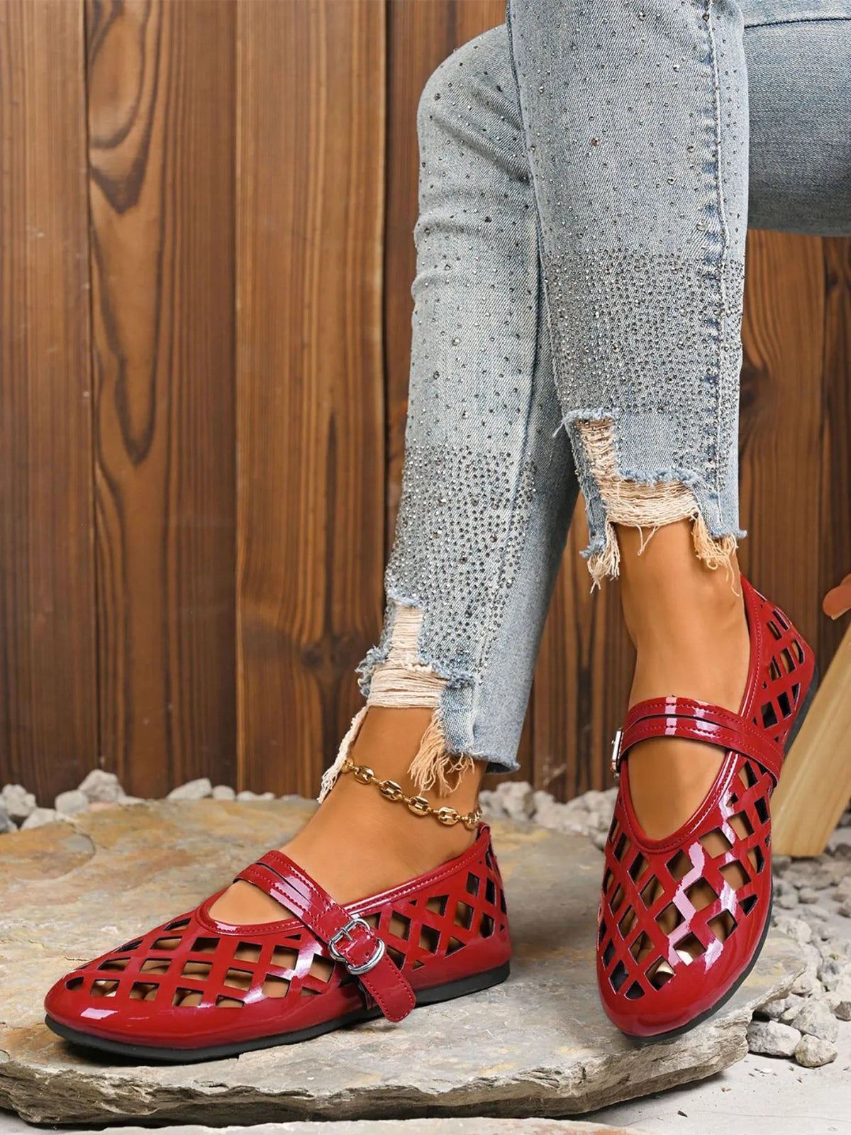 Women's vegan leather flat sandals with cutout design and round toe by Plush Fashion Hub, shown from a side view.