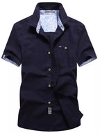 Men's casual short-sleeve button-up shirt in plus size by Trendsi, with a relaxed fit and classic collar, shown on a model.