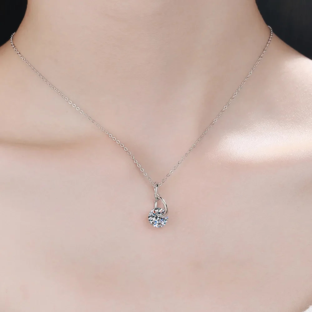 Sterling silver moissanite necklace with a 2-carat central stone, elegant jewelry piece from Plush Fashion Hub.