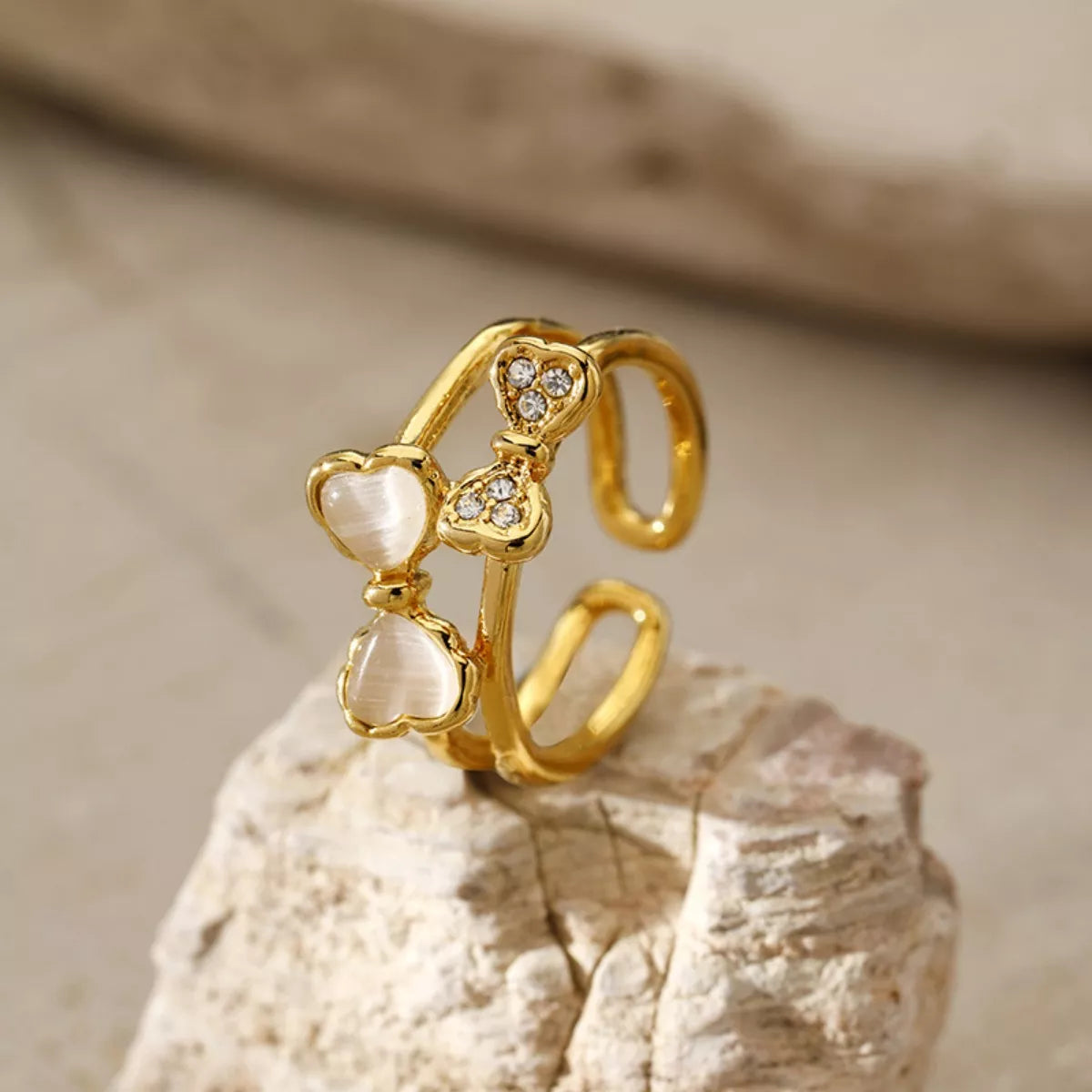 18K gold-plated open bow ring from Plush Fashion Hub, featuring a delicate design and shiny finish on a plain background.