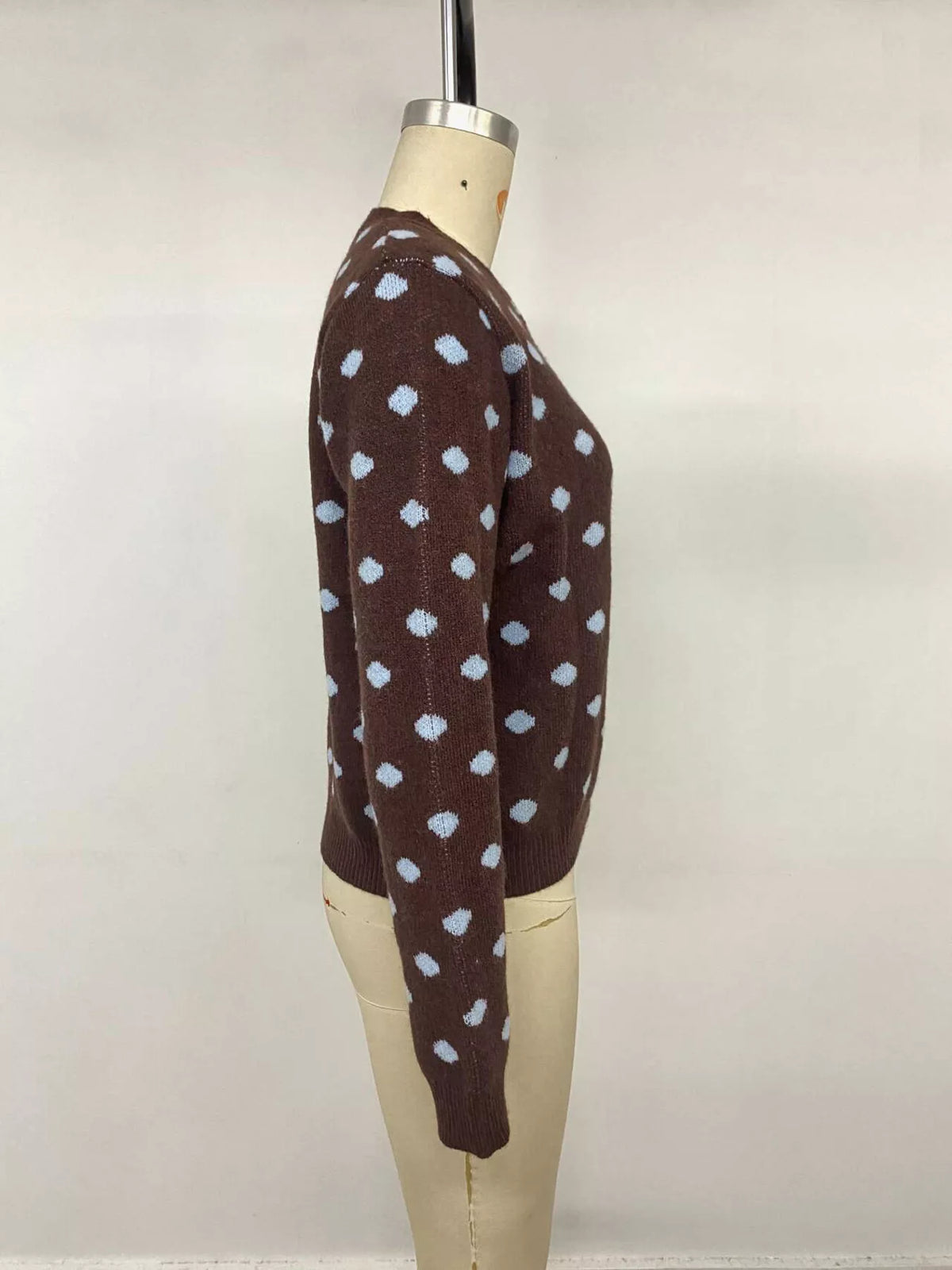 Women’s polka dot button-up cardigan by Trendsi featuring a cozy knit fabric and classic design, perfect for stylish layering.