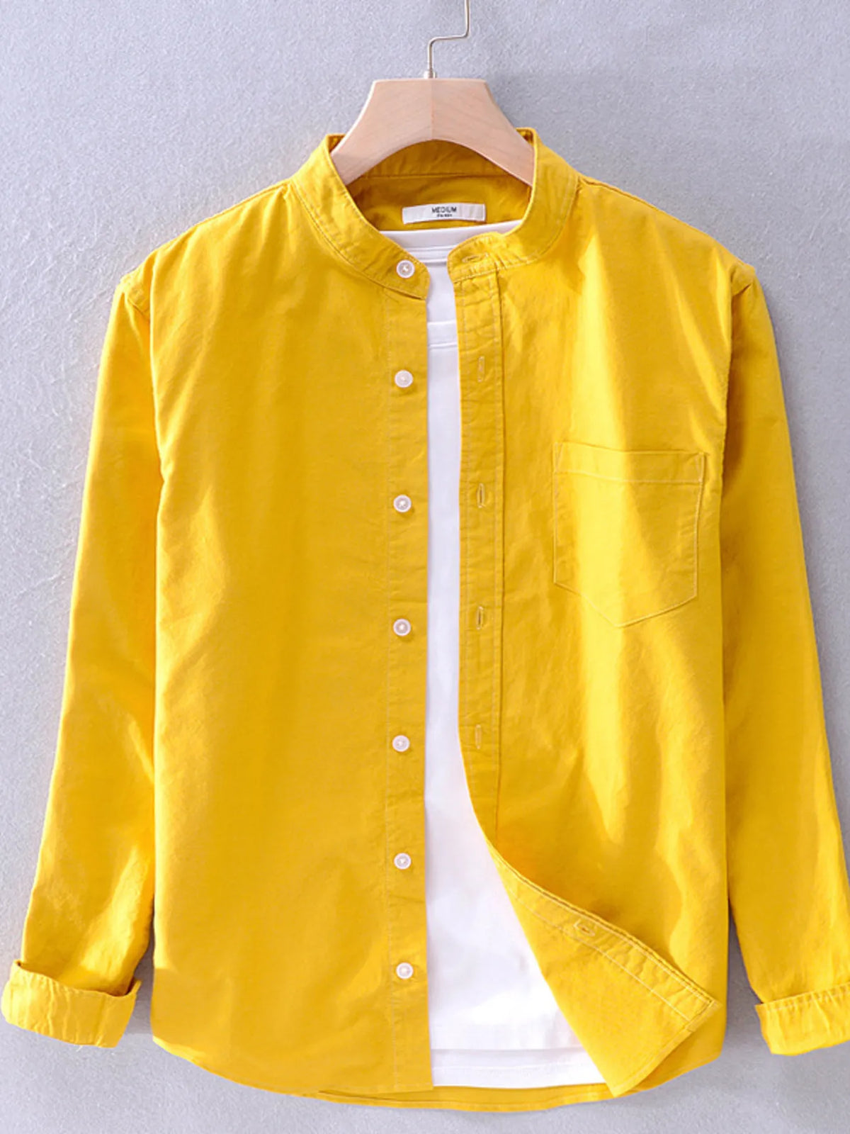 Plus size men's button-up long sleeve shirt from Trendsi, shown in a classic style with a collar and button closure.