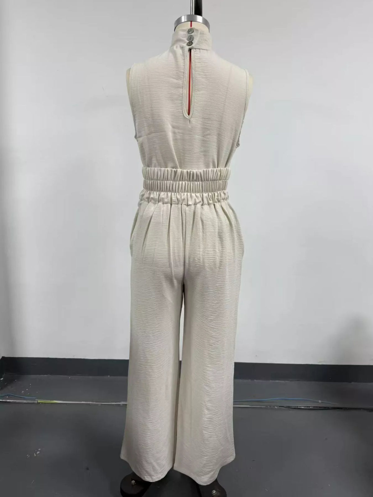 Plus size full length sleeveless wide-leg jumpsuit with smocked waist by Trendsi, shown in a stylish, comfortable fit.