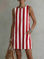 Women's striped color-block sleeveless mini dress in loose fit, casualwear by Plush Fashion Hub, featuring vibrant color blocks and a relaxed style.