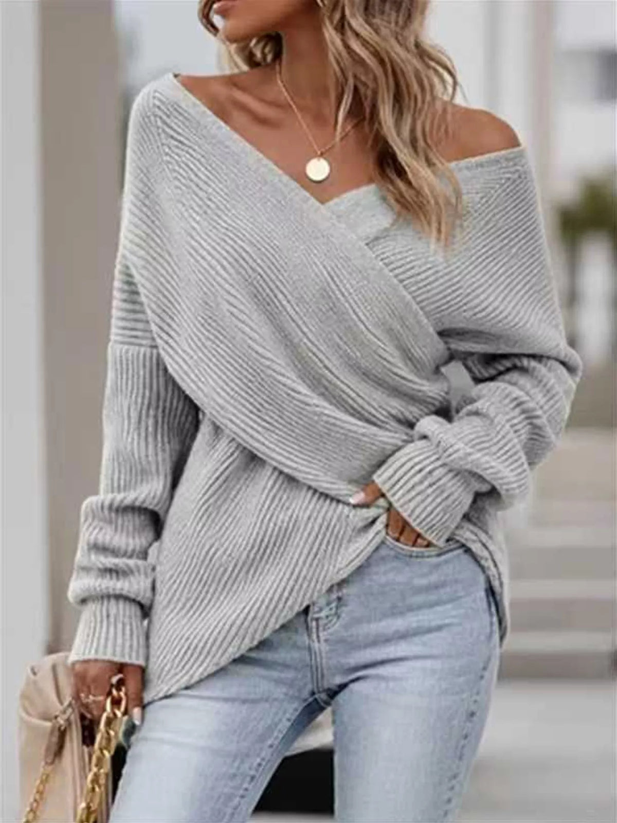 Crisscross ribbed knit long sleeve sweater by Trendsi, featuring a stylish design and fitted silhouette in soft fabric.