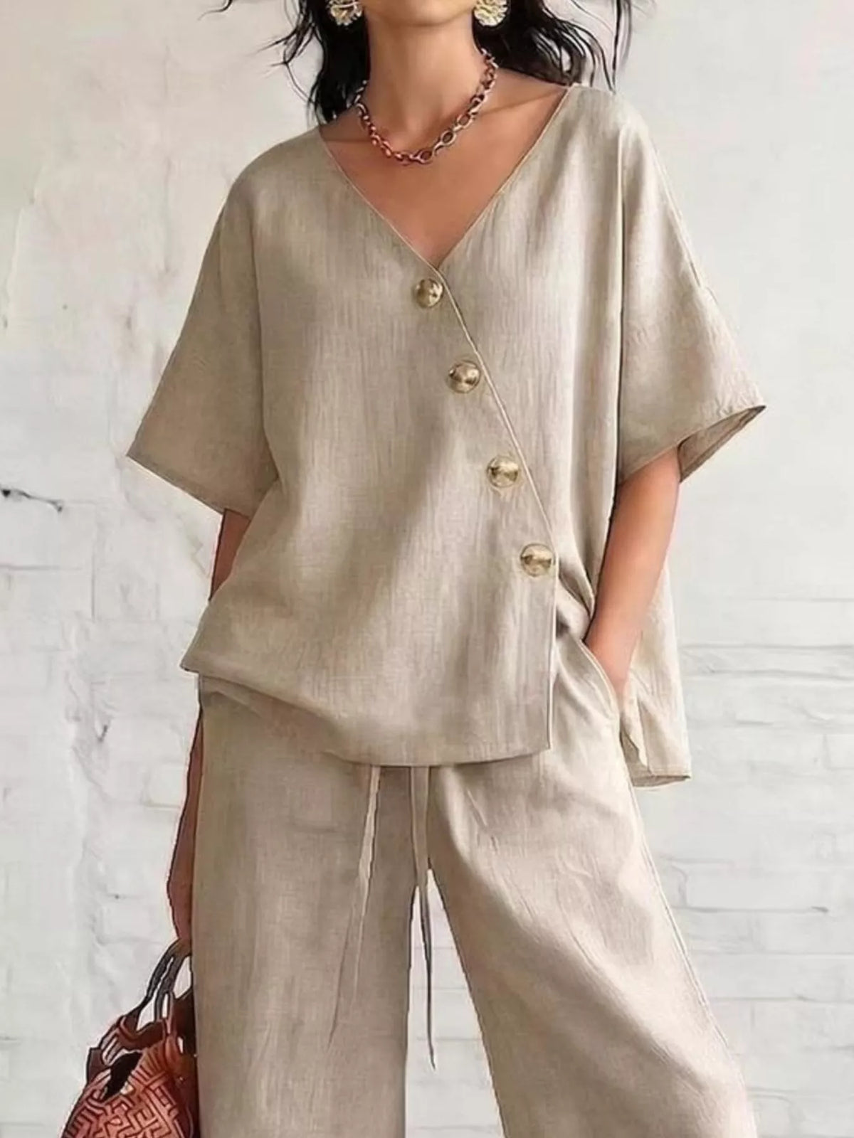 Plus size full surplice half-sleeve top and wide-leg pants set by Trendsi, displayed on a model with a neutral background.