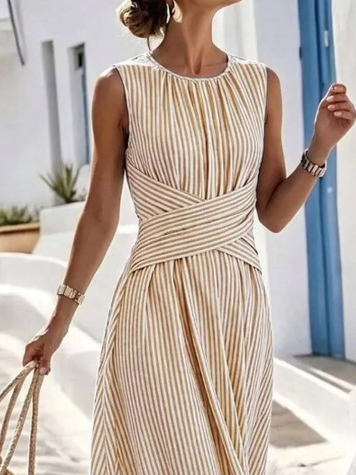 Plus size striped sleeveless maxi dress by Trendsi, featuring a flowing full-length design with bold vertical stripes.