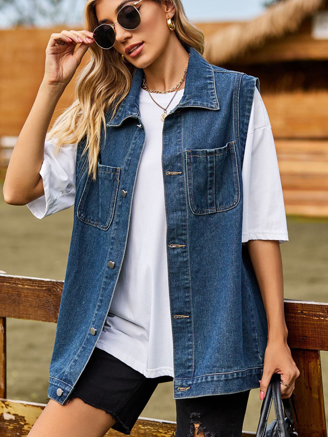 Light blue button-down denim vest from Plush Fashion Hub with classic collar and sleeveless design, styled for casual wear.