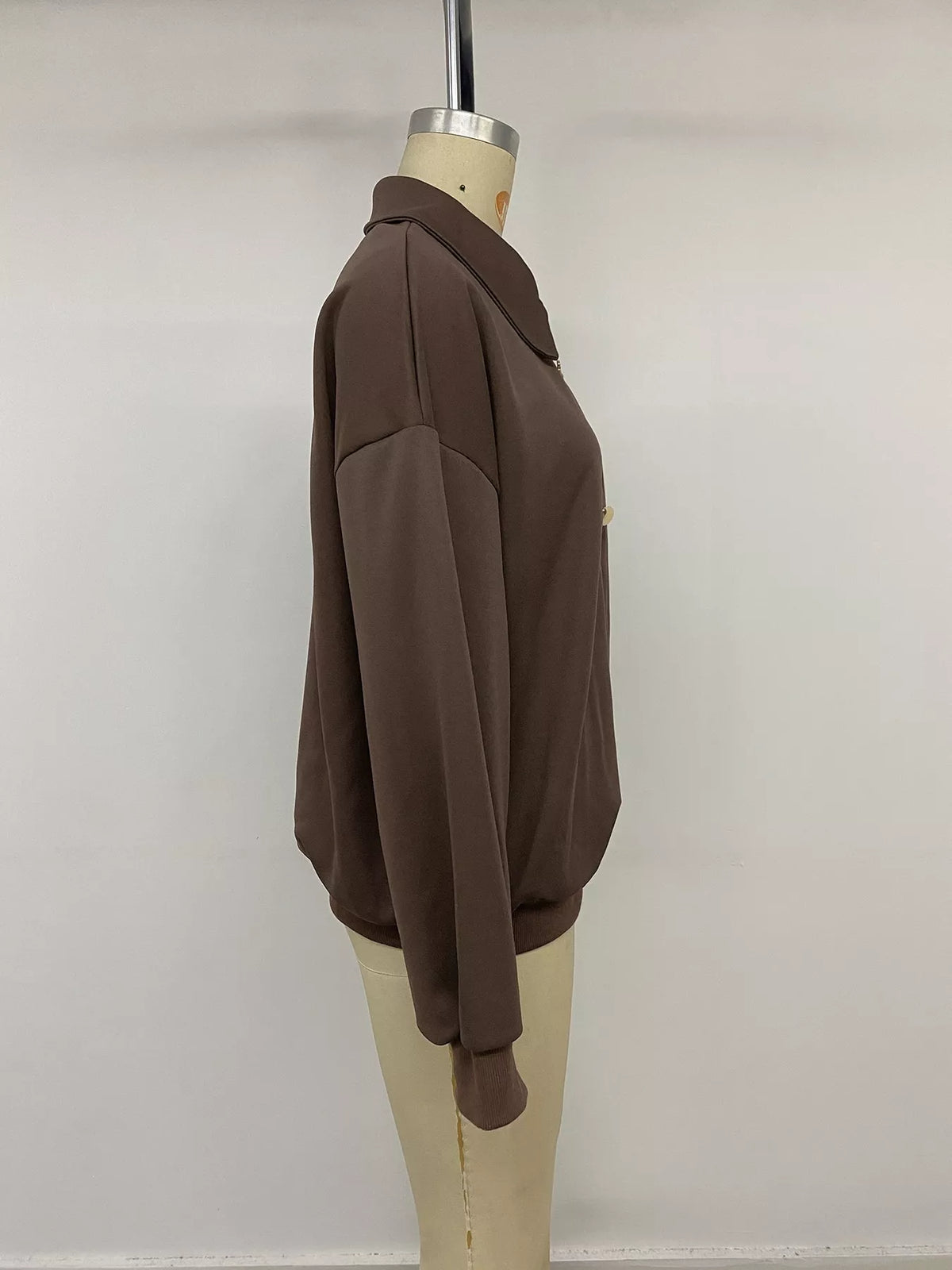 Trendsi polo collar dropped shoulder sweatshirt featuring a relaxed fit and casual style, shown on a model in a neutral setting.