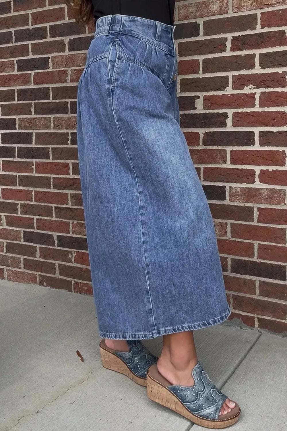 High-waisted wide-leg button-fly jeans made from classic cotton denim with a relaxed fit and stylish design.