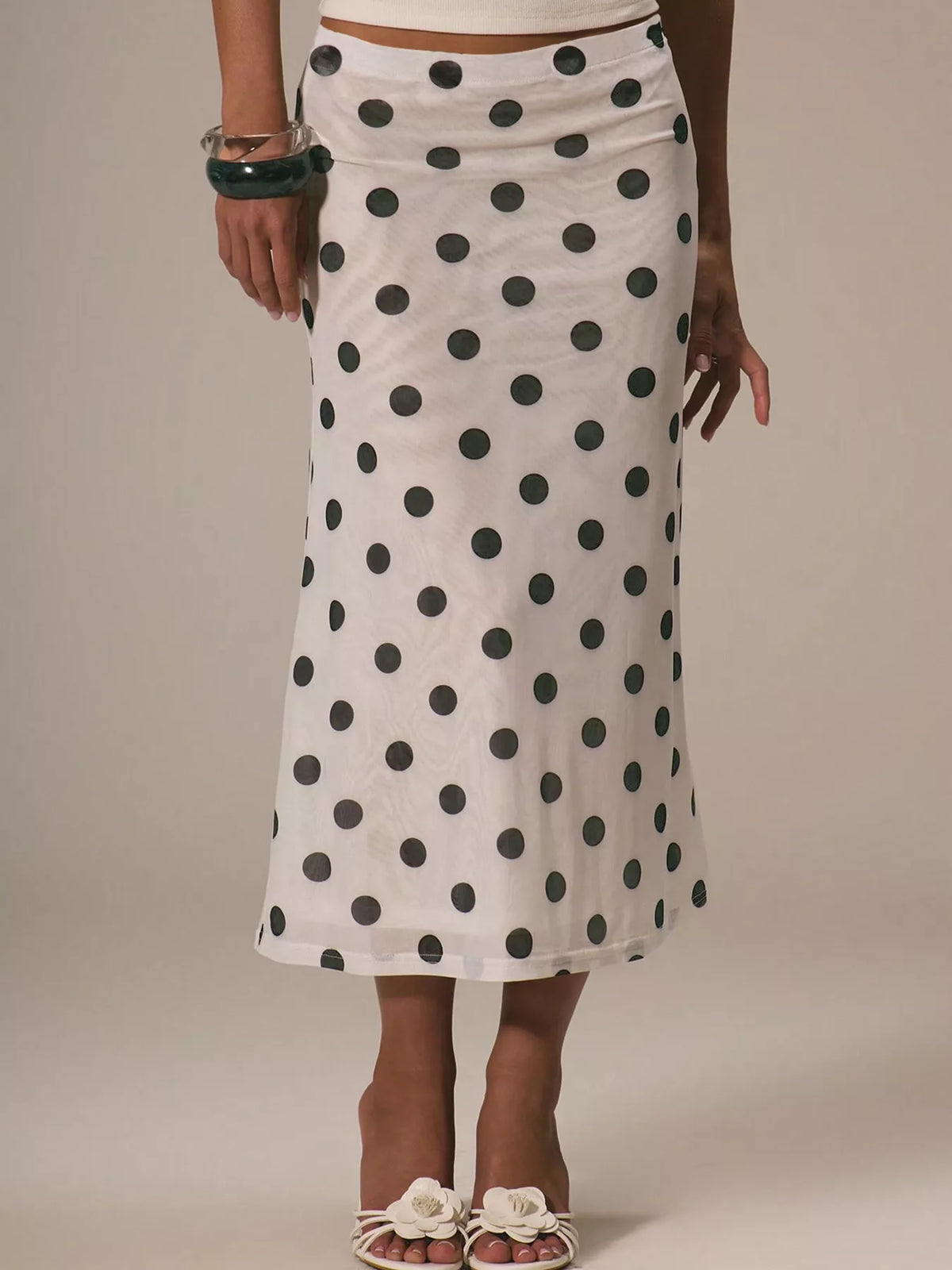 Women's vintage-inspired polka dot midi skirt by Plush Fashion Hub, high-waisted A-line design, perfect for stylish casual wear.