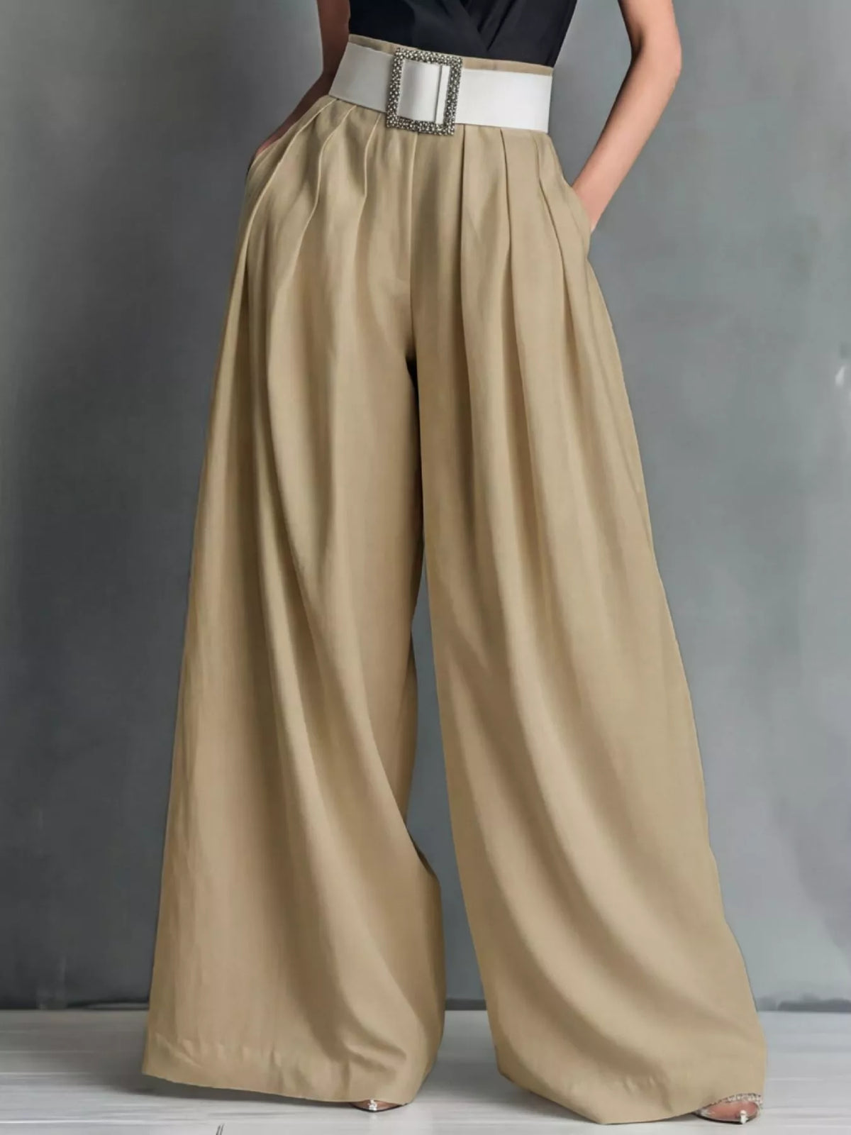 High-waisted wide-leg pants by Plush Fashion Hub, shown in a neutral color, styled casually on a model.