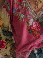 Plus size floral embroidered V-neck blouse by Trendsi, elegant women's top with intricate embroidery and lightweight fabric.