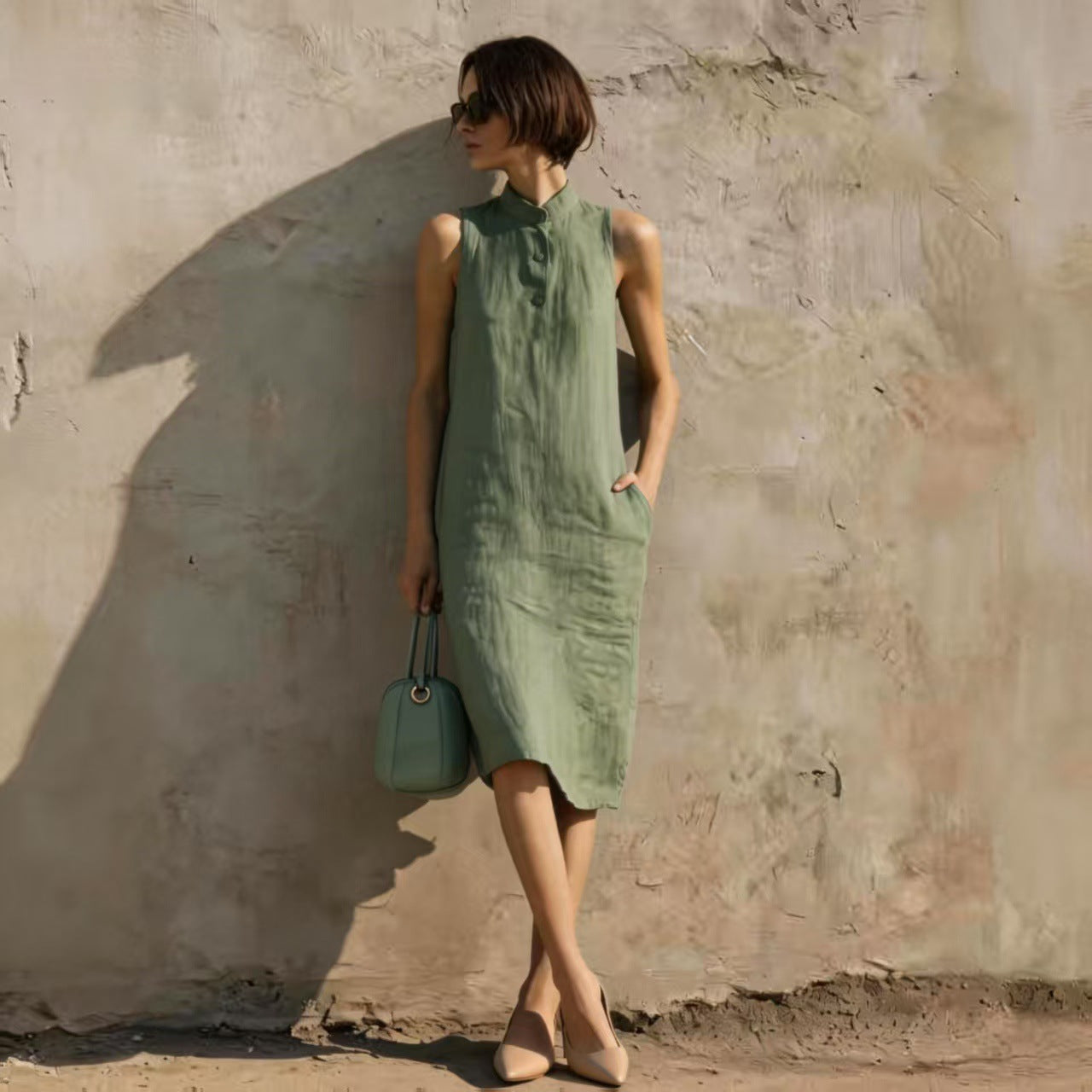 Women's sleeveless A-line midi dress in solid cotton linen fabric, featuring a casual, relaxed fit perfect for summer wear.