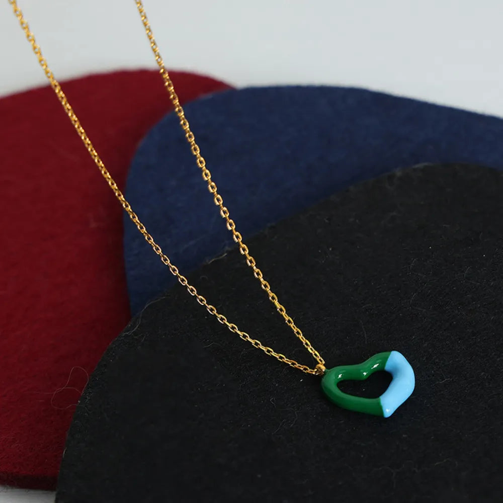 Titanium steel heart pendant necklace with polished finish, featuring a sleek and modern design, ideal for elegant jewelry styling.