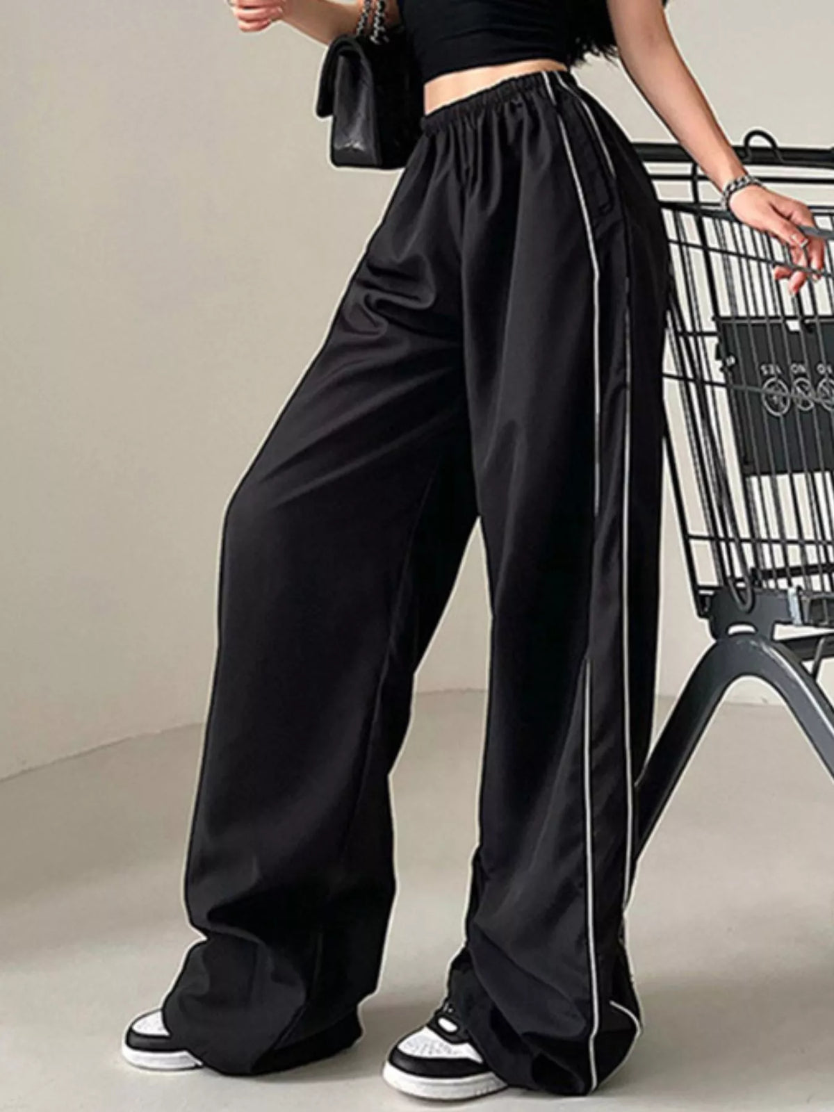 Women's lightweight high-rise wide-leg pants with elastic waist from Plush Fashion Hub, shown as a stylish dress in soft fabric.