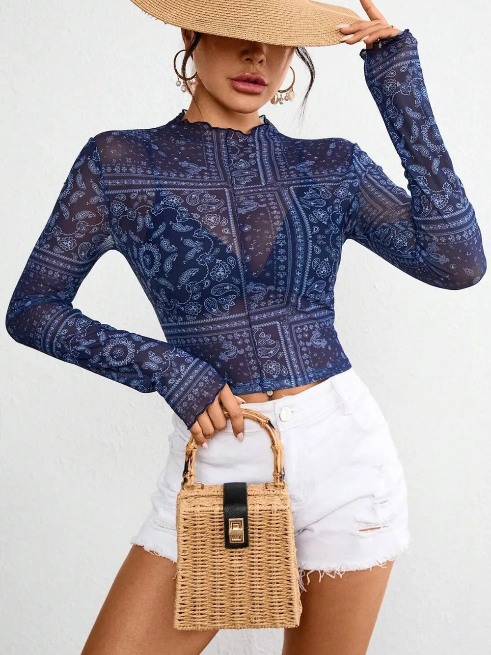 Sheer long sleeve top with paisley pattern, mock neck design, from Plush Fashion Hub, shown on a hanger.