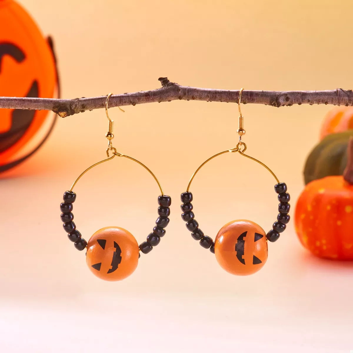 18K gold-plated Halloween bead earrings with orange and black beads, featuring a festive and stylish design.