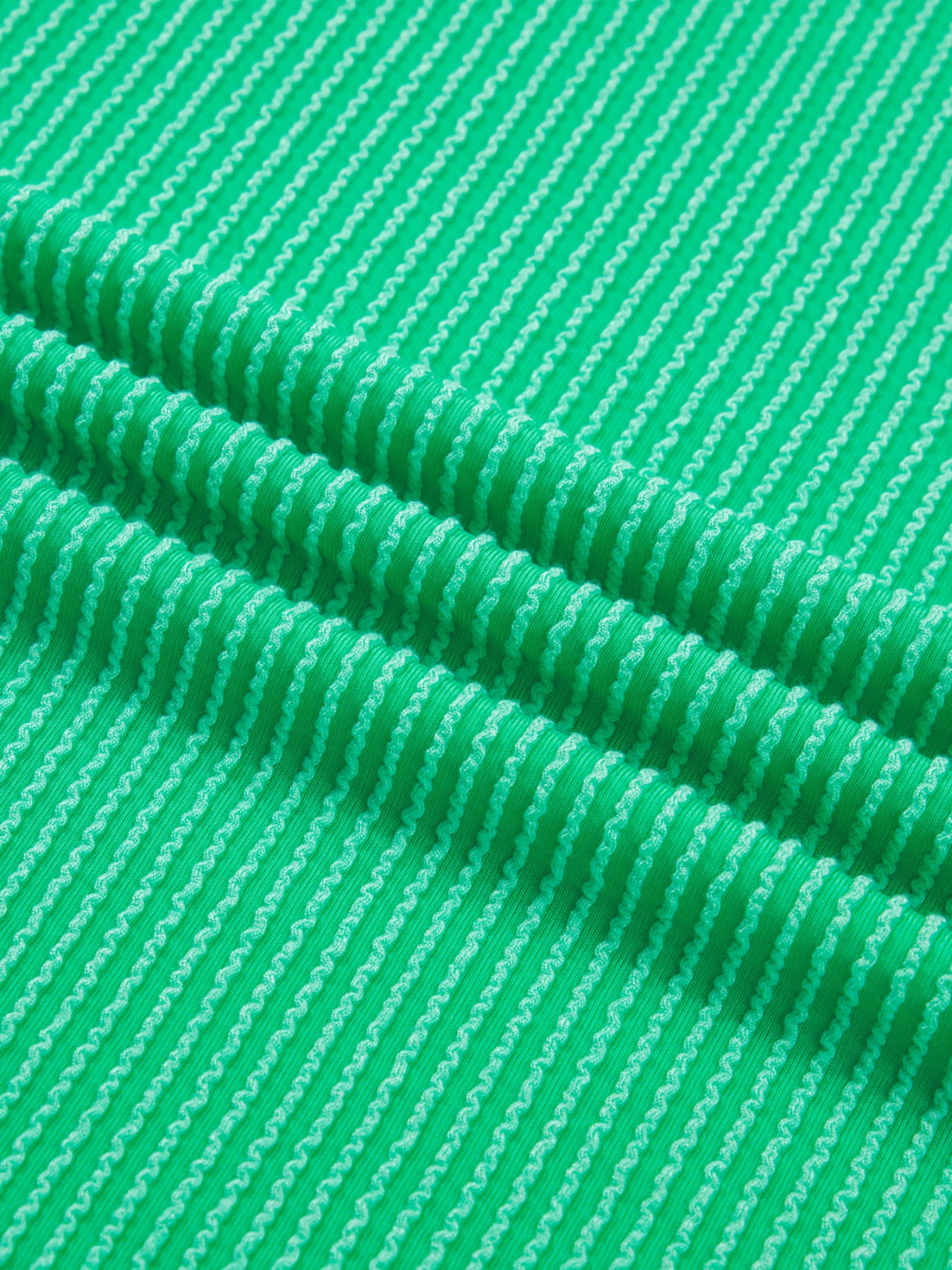 Women’s ribbed short sleeve T-shirt with twist hem and contrast stitching from Plush Fashion Hub, shown in a close-up image.