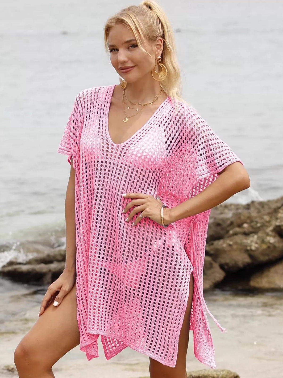 Openwork V-neck slit cover-up by Plush Fashion Hub, lightweight beachwear with intricate openwork details and a flowing V-neck design.