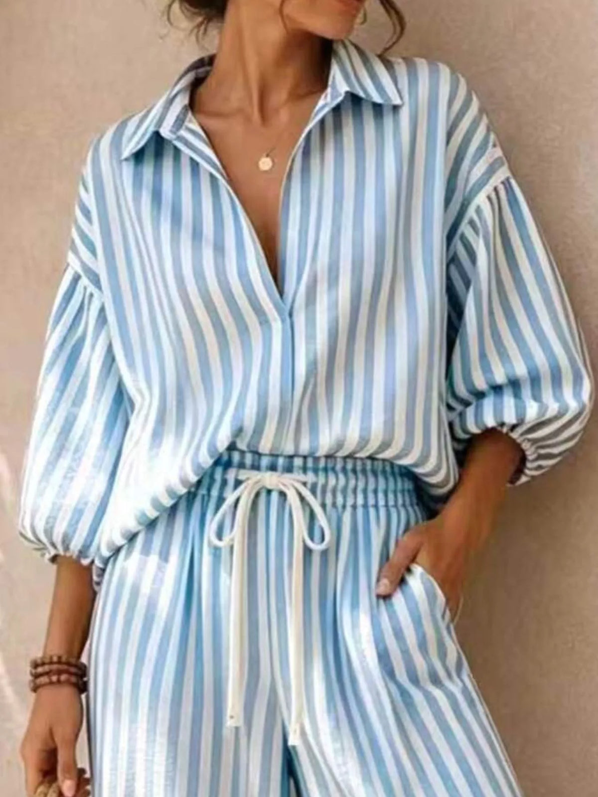 Plus size striped puff sleeve shirt and wide-leg drawstring pants set by Trendsi, stylish matching outfit with comfortable fit.