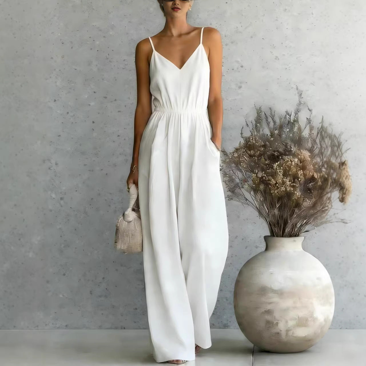 Women's sleeveless wide-leg jumpsuit by FitiqueFit in multiple colors, styled on a model, showcasing relaxed fit and trendy design.