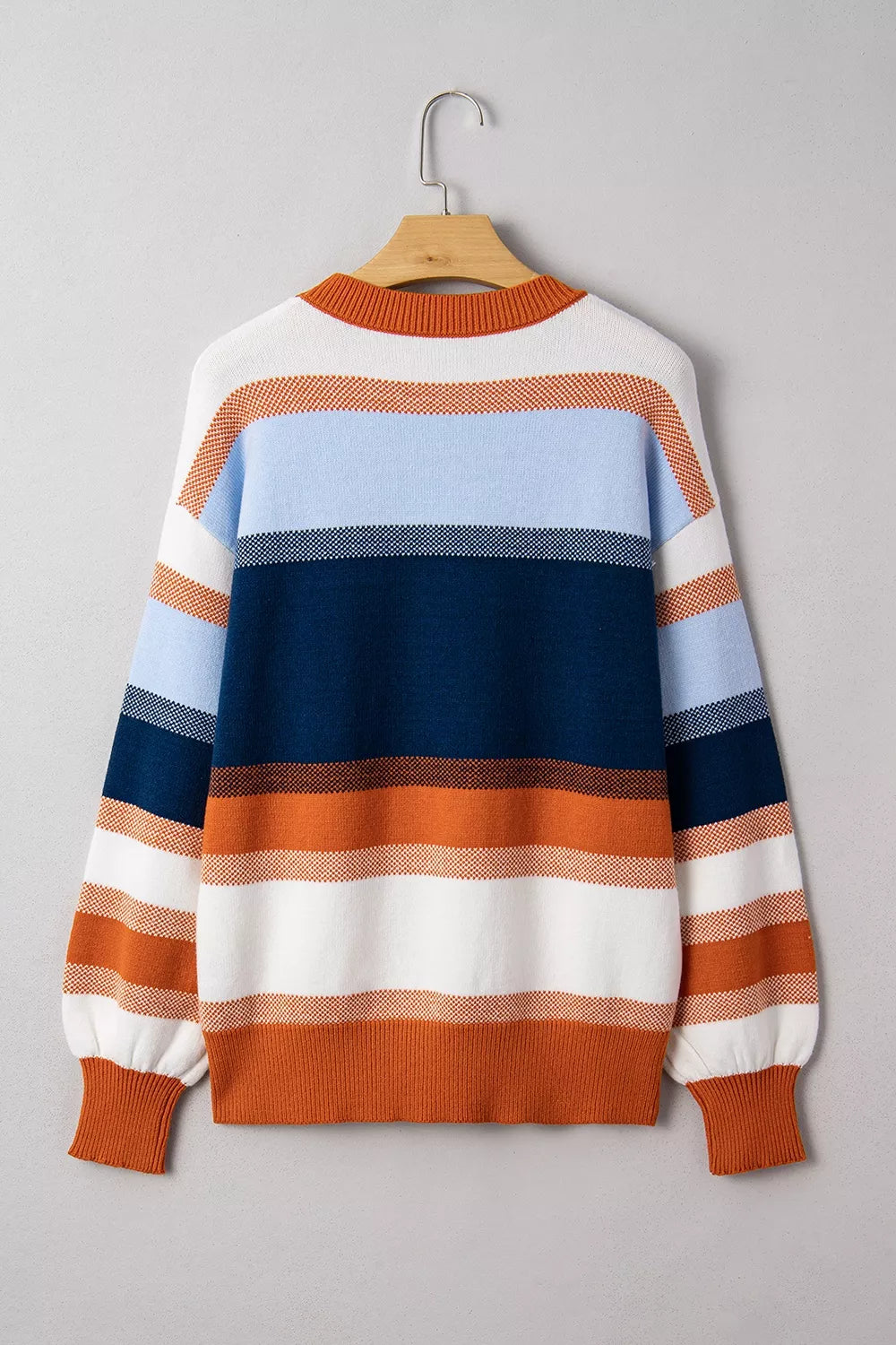 Color block round neck sweater from Trendsi featuring a stylish, casual design with bold color blocking and a comfortable fit.