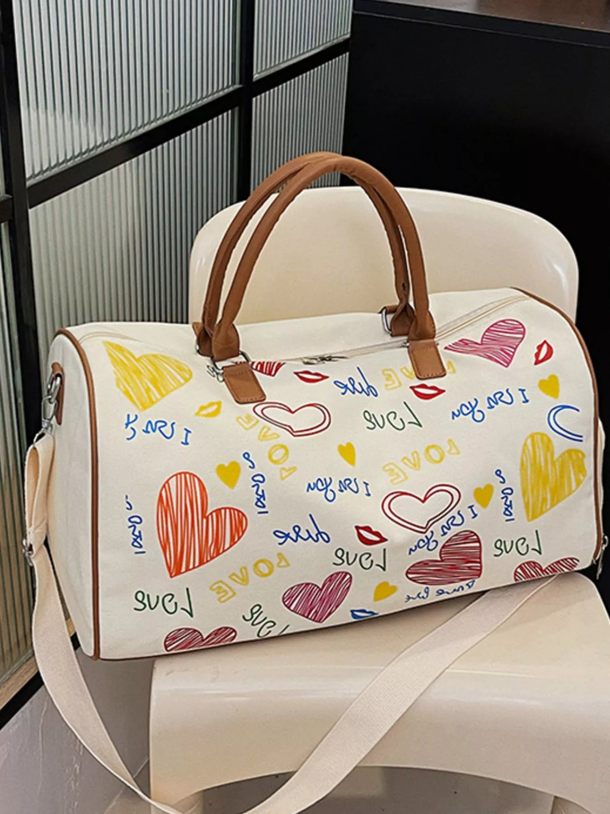 Printed Plush Fashion Hub duffel bag with adjustable strap, featuring colorful design and spacious storage for travel or gym use.